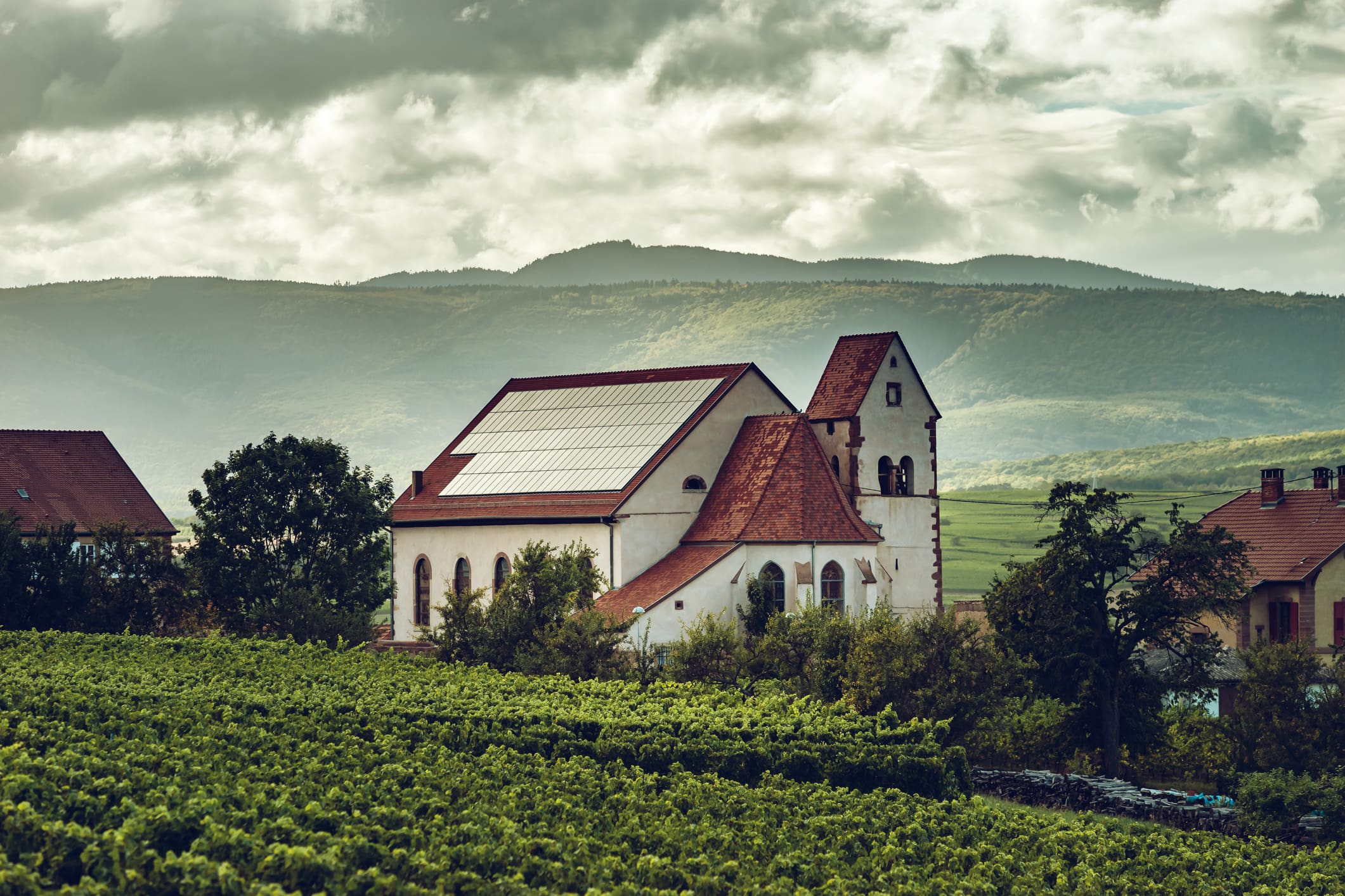 Rooftop solar panels on a house in the countryside.