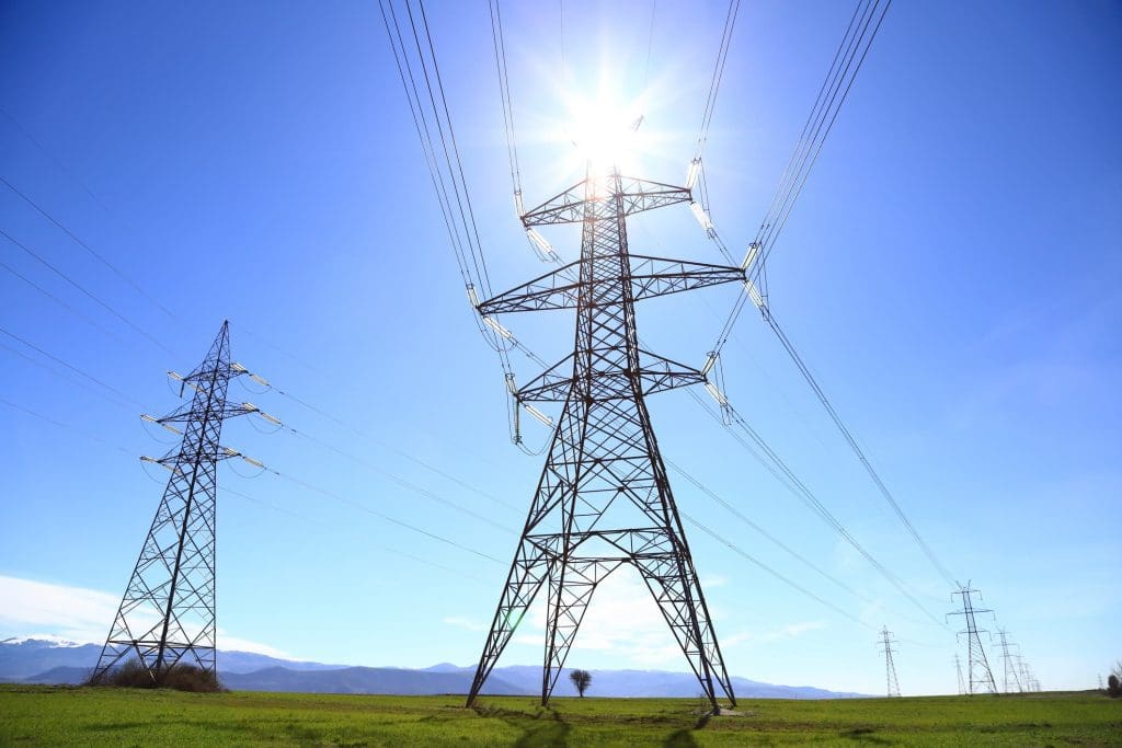 Power lines beneath the sun