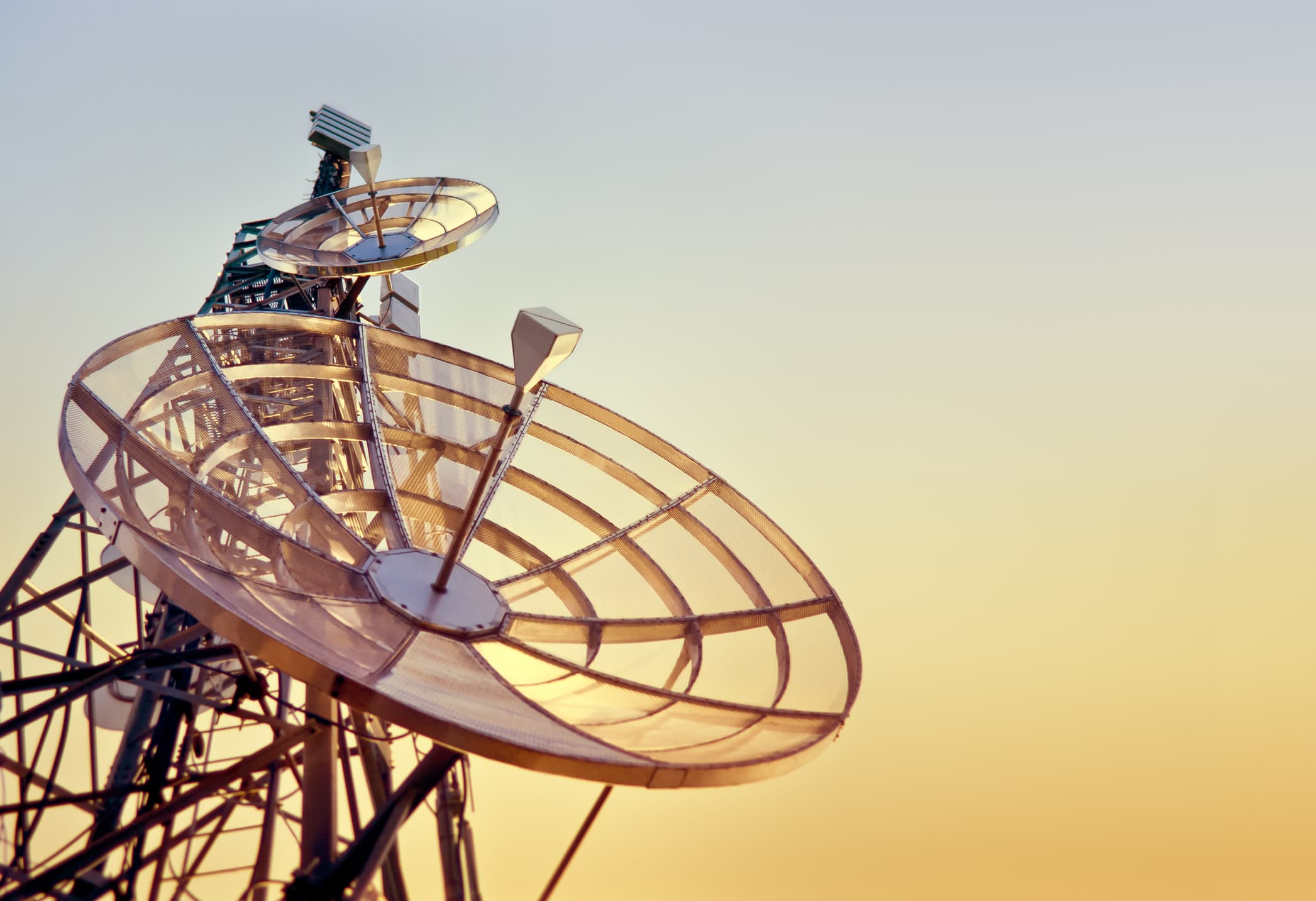 A photo of a telecommunications tower at sunset