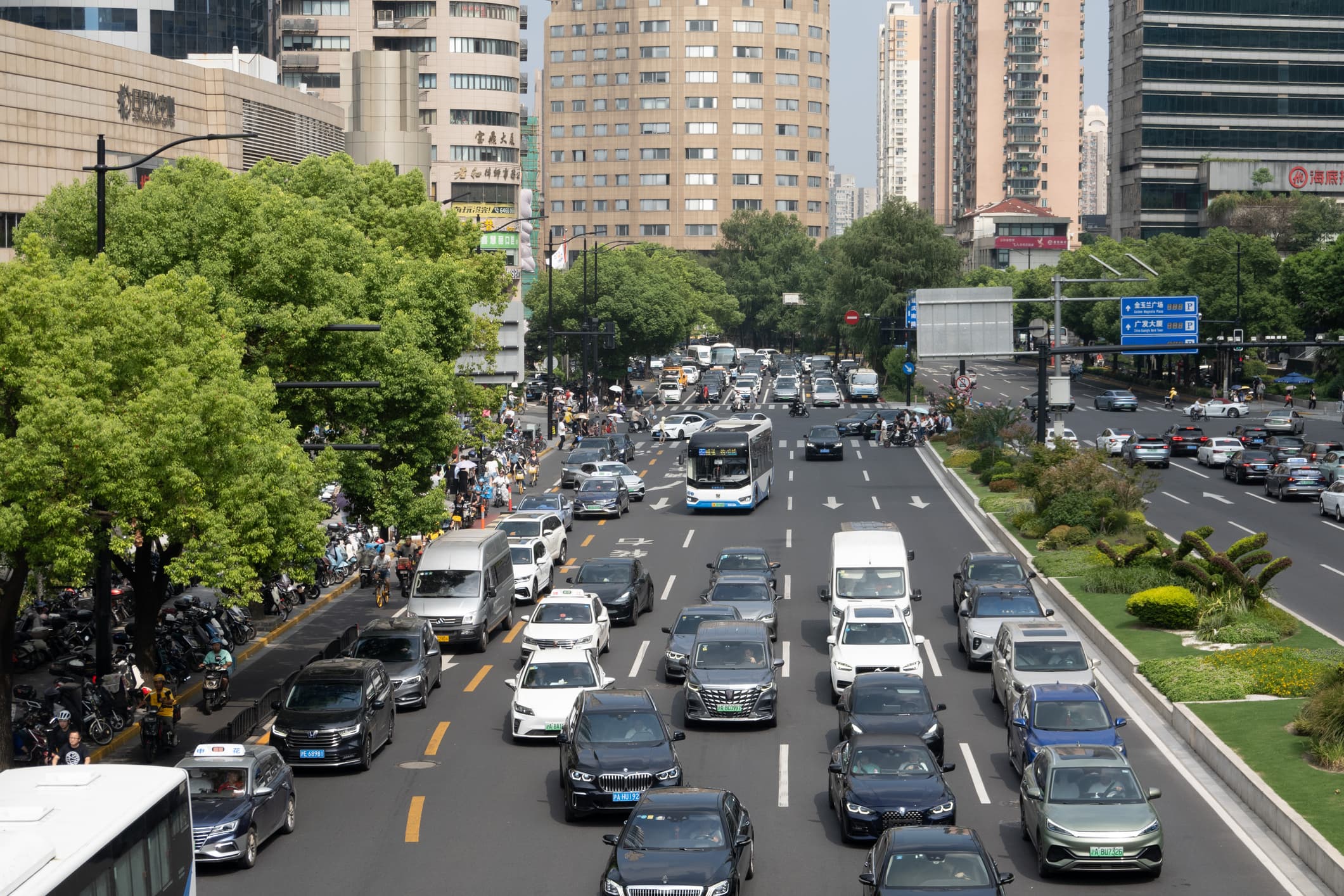 A photo of traffic in Shanghai, which has lots of electric vehicles
