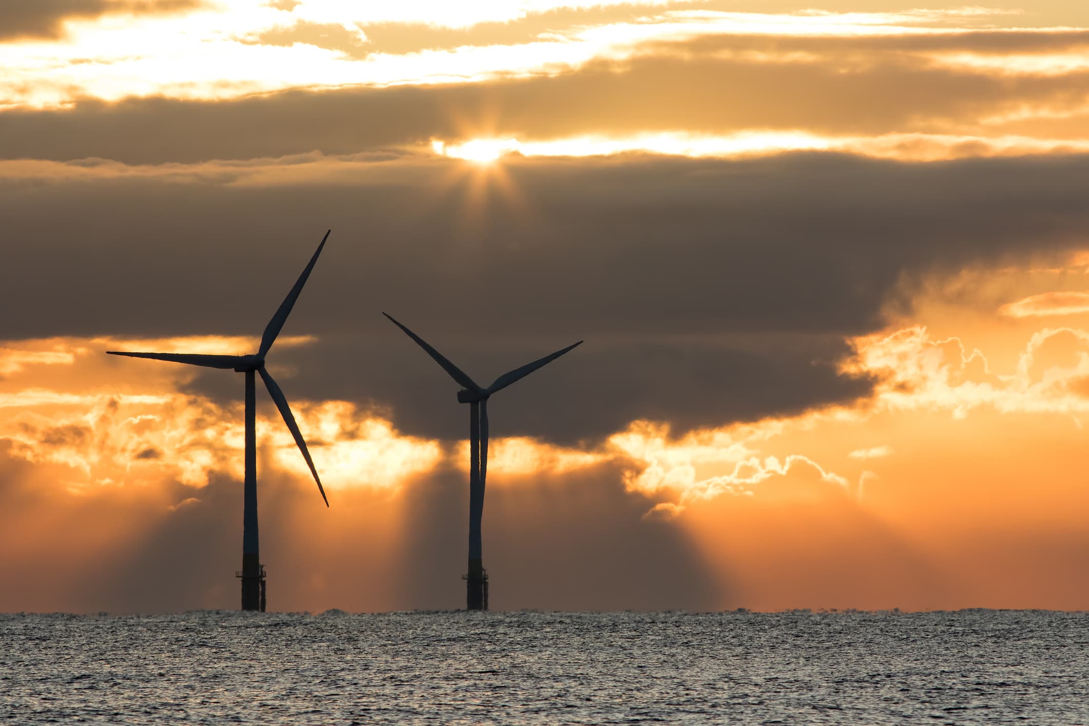 Photo of offshore wind turbines in the UK producing renewable, clean power.