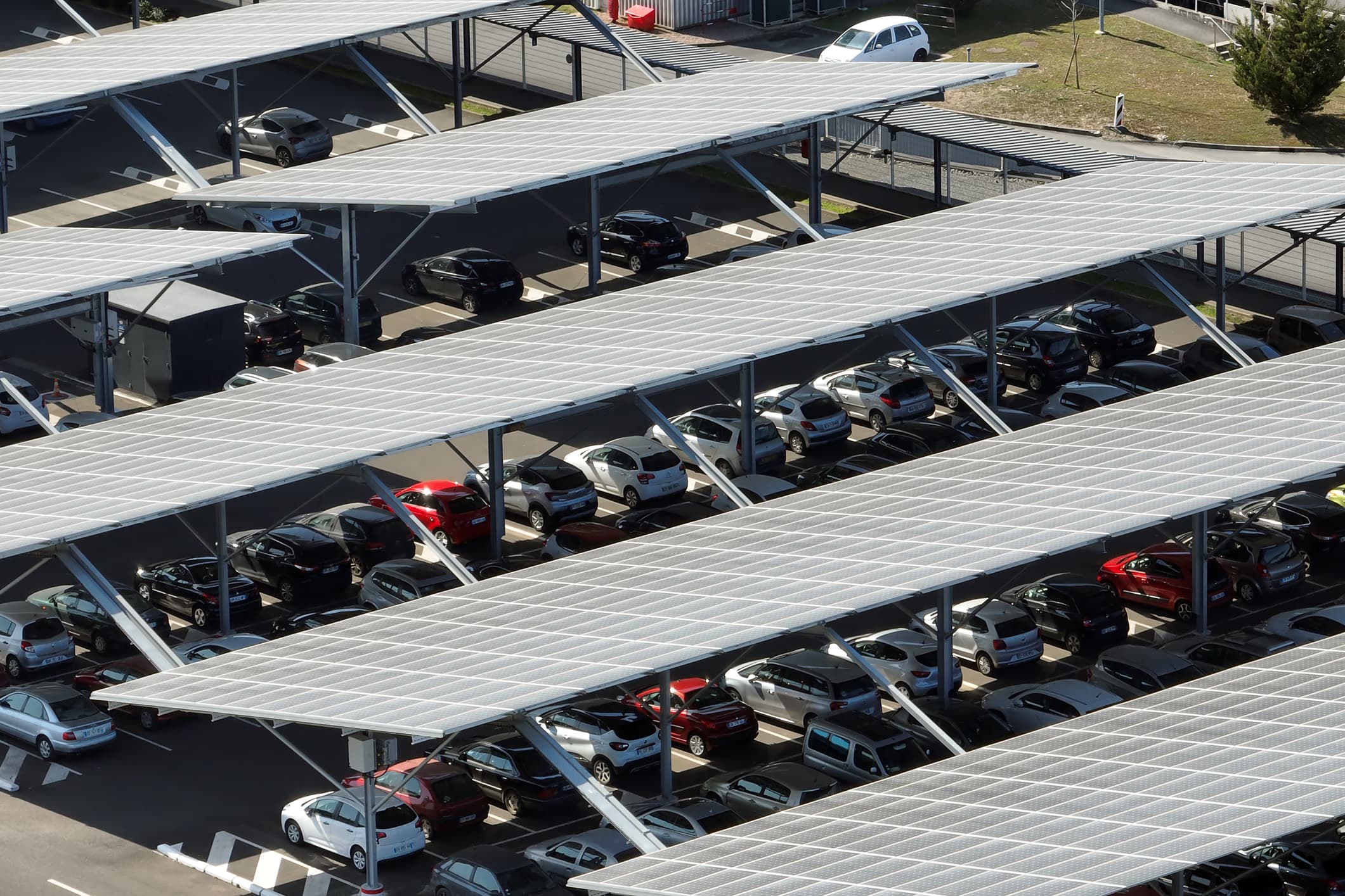 A photo of a parking lot covered in solar panels.