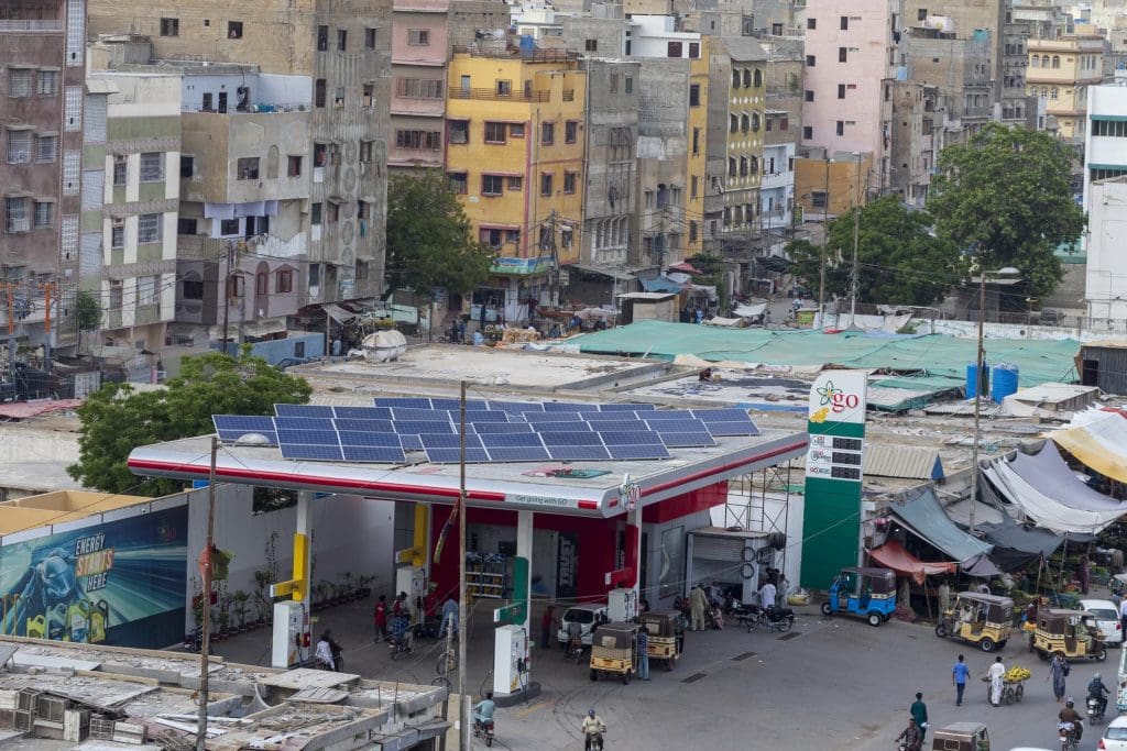 A photo of a petrol station in Pakistan with solar panels on its roof.