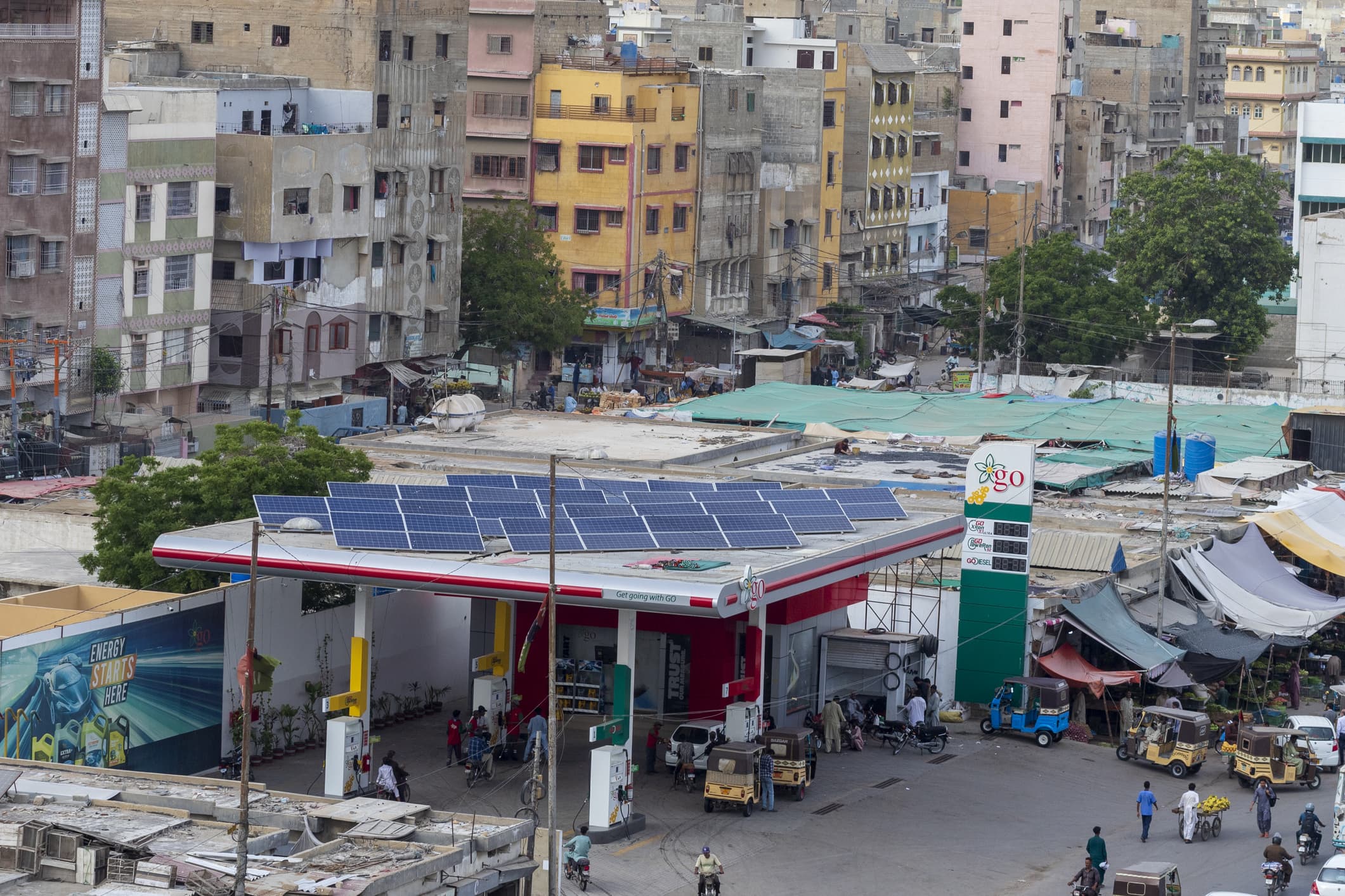 A photo of a petrol station in Pakistan with solar panels on its roof.